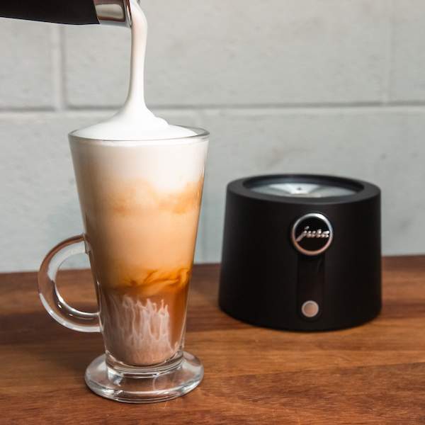 JURA Autofrother velvetiser pouring cappuccino style milk.